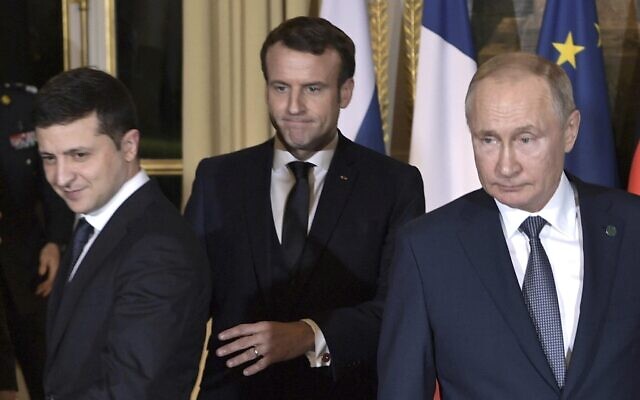 French President Emmanuel Macron, center, Russian President Vladimir Putin, right, and Ukrainian President Volodymyr Zelenskiy, left, arrive for a working session at the Elysee Palace, in Paris, France, Dec. 9, 2019. (Alexei Nikolsky, Sputnik, Kremlin Pool Photo via AP) French President Emmanuel Macron, center, Russian President Vladimir Putin, right, and Ukrainian President Volodymyr Zelenskiy, left, arrive for a working session at the Elysee Palace, in Paris, France, Dec. 9, 2019. (Alexei Nikolsky, Sputnik, Kremlin Pool Photo via AP)