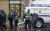 Emergency responders work near a kosher supermarket and a synagogue that were the site of a shooting in Jersey City, New Jersey, December 11, 2019. (AP Photo/Seth Wenig)