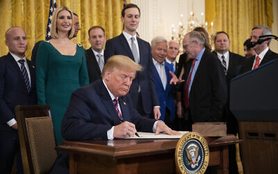 US President Donald Trump signs an executive order combating anti-Semitism in the US during a Hanukkah reception in the East Room of the White House in Washington, December 11, 2019. (Manuel Balce Ceneta/AP)