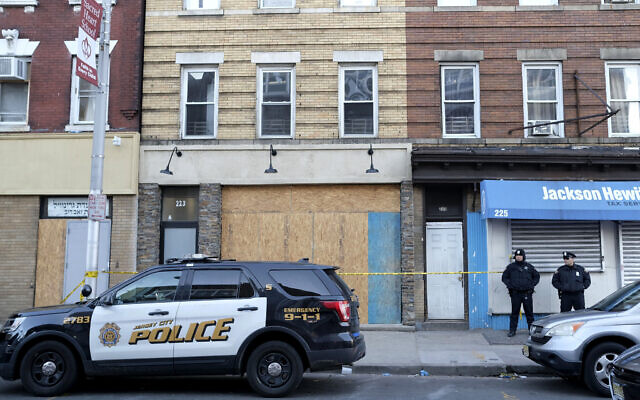 Police officers stand near the scene of a gun fight at a kosher supermarket and next door yeshiva in Jersey City, New Jersey, December 12, 2019. (AP Photo/Seth Wenig) Police officers stand near the scene of a gun fight at a kosher supermarket and next door yeshiva in Jersey City, New Jersey, December 12, 2019. (AP Photo/Seth Wenig)