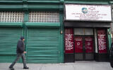 A pedestrian walks past the world headquarters of the Israelite Church of God in Jesus Christ, Thursday, Dec. 12, 2019, in the Harlem neighborhood of New York. (AP/Mary Altaffer)