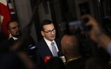 Polish Prime Minister Mateusz Morawiecki speaks with the media at the end of an EU summit in Brussels, on December 13, 2019. (AP Photo/Francisco Seco)