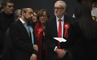 British opposition Labour Party leader Jeremy Corbyn, right, waits for the declaration of his seat in the 2019 general election in Islington, London, December 13, 2019 (AP Photo/Alberto Pezzali)
