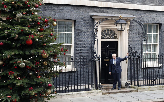 Britain's Prime Minister Boris Johnson waves as he arrives back at 10 Downing Street in London, Dec. 13, 2019 after meeting Queen Elizabeth II to seek her approval to form a new government (AP Photo/Thanassis Stavrakis) Britain's Prime Minister Boris Johnson waves as he arrives back at 10 Downing Street in London, Dec. 13, 2019 after meeting Queen Elizabeth II to seek her approval to form a new government (AP Photo/Thanassis Stavrakis)