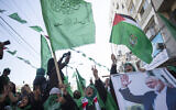Palestinian women, one holding a picture of Hamas movement chief Ismail Haniyeh, attend a mass rally marking the 32nd anniversary of the founding of Hamas on December 14, 2019, in Gaza city. (AP/Khalil Hamra)