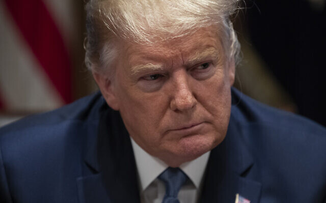 US President Donald Trump listens during a roundtable with governors on government regulations in the Cabinet Room of the White House, in Washington, December 16, 2019. (Evan Vucci/AP) US President Donald Trump listens during a roundtable with governors on government regulations in the Cabinet Room of the White House, in Washington, December 16, 2019. (Evan Vucci/AP)