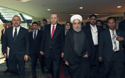Turkey's President Recep Tayyip Erdogan center left, walks with Iran's President Hassan Rouhani, centre right, following their meeting at the sidelines of the Kuala Lumpur Summit in Kuala Lumpur, Malaysia on December 19, 2019. (Presidential Press Service via AP, Pool)