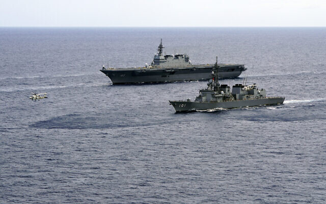 In this June 28, 2019, file photo, Japan's Maritime Self-Defense Force helicopter carrier Izumo (DDH-183) and destroyer JS Murasame (DD-101) participate in drills that included maritime navigation and emergency response exercises in Sulu Sea. (AP/Emily Wang) In this June 28, 2019, file photo, Japan's Maritime Self-Defense Force helicopter carrier Izumo (DDH-183) and destroyer JS Murasame (DD-101) participate in drills that included maritime navigation and emergency response exercises in Sulu Sea. (AP/Emily Wang)