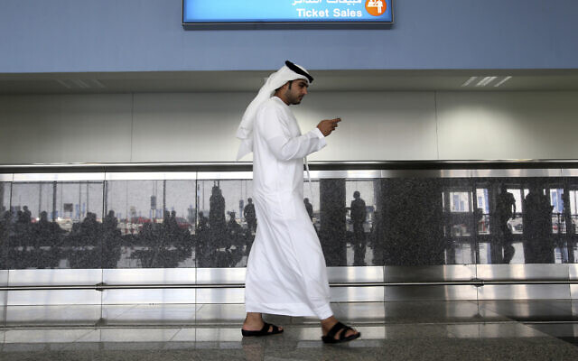 Illustrative: A worker looks at his mobile phone at Al Maktoum International Airport in Dubai, United Arab Emirates, on October 27, 2013. (Patrick Castillo/ Emarat Al Youm via AP, File) Illustrative: A worker looks at his mobile phone at Al Maktoum International Airport in Dubai, United Arab Emirates, on October 27, 2013. (Patrick Castillo/ Emarat Al Youm via AP, File)