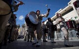 A Palestinian Scout marching band parades during Christmas celebrations outside the Church of the Nativity, built atop the site where Christians believe Jesus Christ was born, on Christmas Eve, in the West Bank City of Bethlehem, December 24, 2019. (AP Photo/Majdi Mohammed)