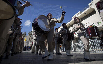 A Palestinian Scout marching band parades during Christmas celebrations outside the Church of the Nativity, built atop the site where Christians believe Jesus Christ was born, on Christmas Eve, in the West Bank City of Bethlehem, December 24, 2019. (AP Photo/Majdi Mohammed)