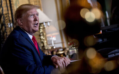 US President Donald Trump speaks to members of the media following a Christmas Eve video teleconference with members of the military at his Mar-a-Lago estate in Palm Beach, Florida, December 24, 2019. (Andrew Harnik/AP)