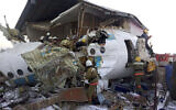 In this handout photo provided by the Emergency Situations Ministry of the Republic of Kazakhstan, police and rescuers work on the side of a plane crash near Almaty International Airport, outside Almaty, Kazakhstan, Friday, Dec. 27, 2019. ( Emergency Situations Ministry of the Republic of Kazakhstan photo via AP)