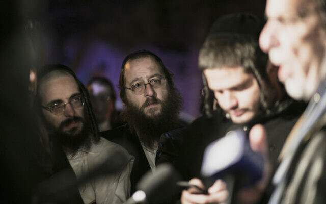 Orthodox Jews listen to ex-NY state assemblyman Dov Hikind speak in Monsey, New York, December 29, 2019, following a stabbing rampage late Saturday during a Hanukkah celebration. (AP/Allyse Pulliam) Orthodox Jews listen to ex-NY state assemblyman Dov Hikind speak in Monsey, New York, December 29, 2019, following a stabbing rampage late Saturday during a Hanukkah celebration. (AP/Allyse Pulliam)