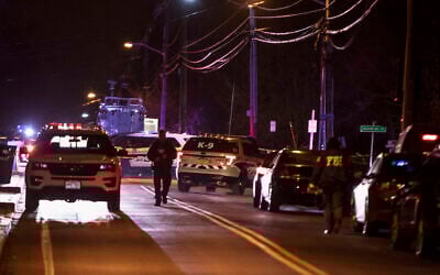 Authorities gather on a street in Monsey, New York, Sunday, December 29, 2019, following a stabbing rampage late Saturday during a Hanukkah celebration. (AP/Allyse Pulliam)