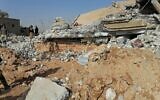 Fighters from the Kataeb Hezbollah, or Hezbollah Brigades militia, inspect the destruction of their headquarters in the aftermath of a US airstrike in Qaim, Iraq, December 30, 2019. (AP Photo)