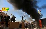 Protesters burn property in front of the US embassy compound, in Baghdad, Iraq, Dec. 31, 2019. (Khalid Mohammed/AP)