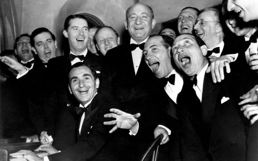 Irving Berlin, at the piano, and friends celebrate the 25th year since he wrote 'Alexander's Rag Time Band' at a banquet in his honor in Hollywood, California, January 20, 1936.  Standing behind Berlin, at right, is Joseph Schenck, film producer.  In front row singing together are two of the Marx Brothers, Chico and Harpo.  (AP Photo)
