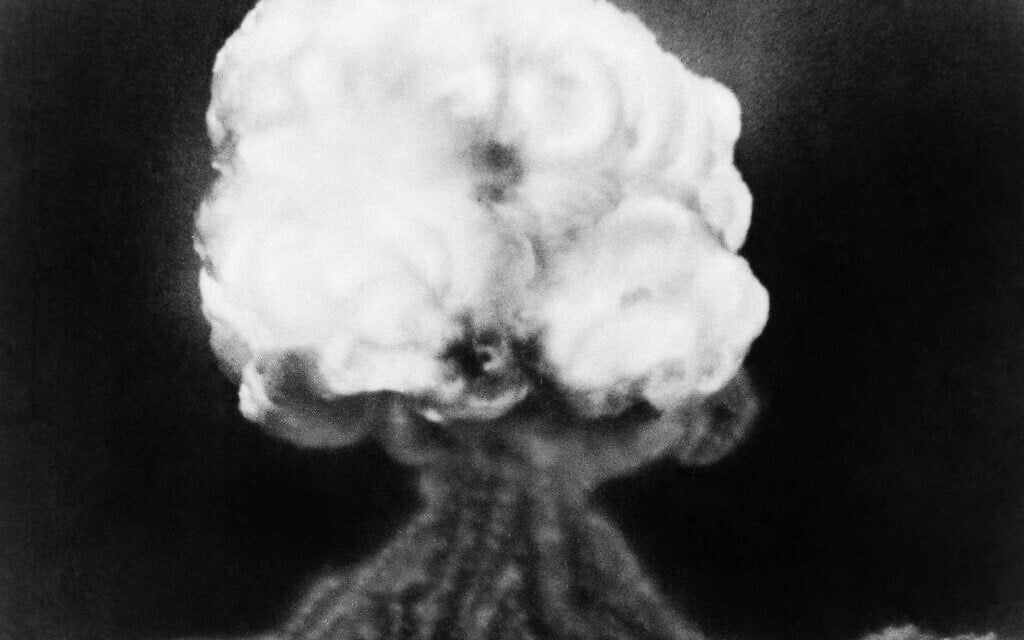 This is the mushroom cloud of the first atomic explosion at Trinity Test Site, New Mexico, July 16, 1945.  It left a half-mile wide crater, 10 feet deep at the vent and the sand within the crater had been burned and boiled into a highly radioactive, jade-green, glassy crust. (AP Photo)
