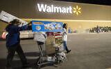 Holiday shoppers leaves Walmart's Black Friday event in Bentonville, Arkansas, on November 24, 2016. (Gunnar Rathbun/AP Images for Walmart)