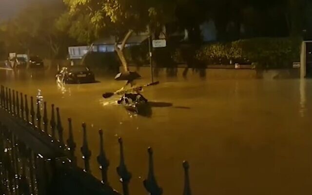 People paddle down a flooded road in the southern Israeli city of Ashkelon on Sunday December 12, 2019 (Screencapture/YouTube) People paddle down a flooded road in the southern Israeli city of Ashkelon on Sunday December 12, 2019 (Screencapture/YouTube)