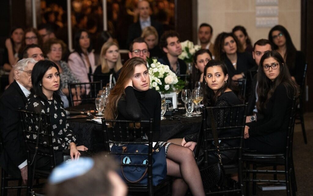 Attendees watch a presentation at the Dinner of Miracles in Toronto, December 15, 2019. (Liora Kogan)