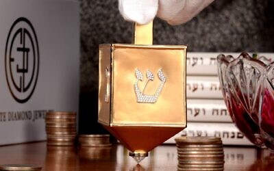 The $70,000 dreidel made of 18K yellow gold and encrusted with 220 round brilliant diamonds created by Estate Diamond Jewelry in New York City was named the world's most valuable dreidel by Guinness World Records. (Courtesy of Estate Diamond Jewelry via JTA)