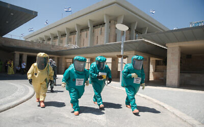 Illustrative: Members of the Knesset Honor Guard, Home Front Command, Firefighters, IDF, and Israel Police, participate in an emergency drill simulating a drone attack on the Knesset territory with a chemical substance, on June 16, 2016. (Yaniv Nadav/Flash90)