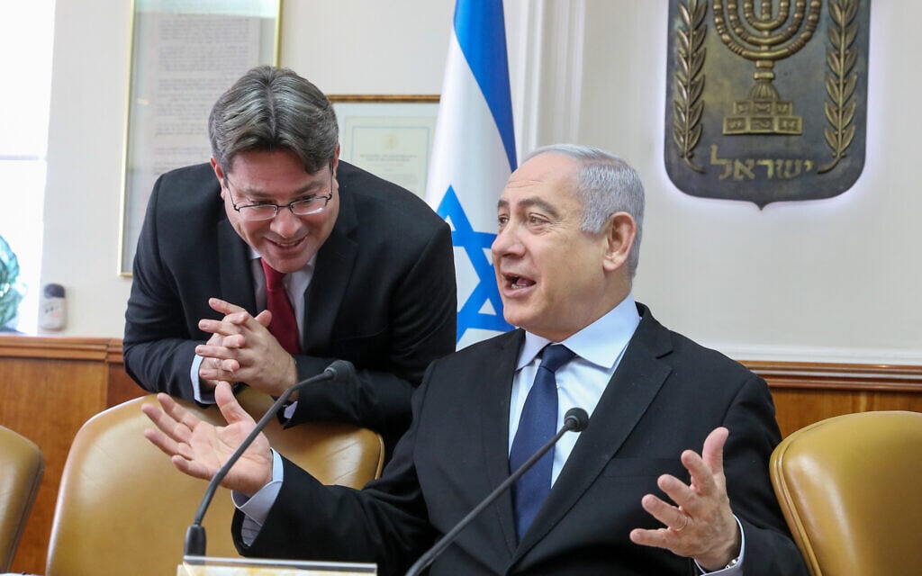 Prime Minister Benjamin Netanyahu with then-Science Minister Ofir Akunis (L) at the start of the weekly cabinet meeting on December 22, 2019, at the Prime Minister's Office in Jerusalem. (Marc Israel Sellem/Pool/Flash90) Prime Minister Benjamin Netanyahu with then-Science Minister Ofir Akunis (L) at the start of the weekly cabinet meeting on December 22, 2019, at the Prime Minister's Office in Jerusalem. (Marc Israel Sellem/Pool/Flash90)
