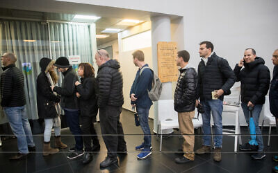 Likud party members at a voting station to cast their vote in primaries for the Likud leadership, in Tel Aviv, on December 26, 2019. (Yonatan Sindel/Flash90)