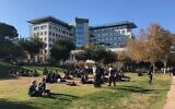 Technion students taking a break on the grass on a sunny winter day when entrepreneurs flocked to the Haifa campus to talk to students December 19, 2019. (Shoshanna Solomon/Times of Israel)