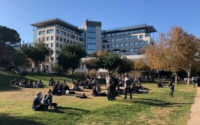 Technion students taking a break on the grass on a sunny winter day when entrepreneurs flocked to the Haifa campus to talk to students December 19, 2019. (Shoshanna Solomon/Times of Israel)