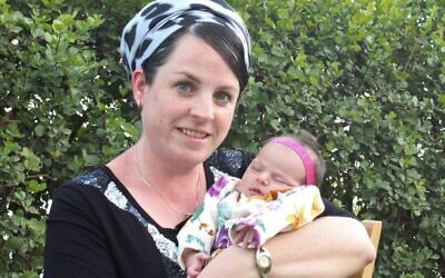 Tzippi Rimel (L) holds her daughter Noam. (Courtesy)
