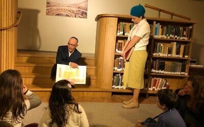 Siblings Yeshayahu and Nechama Leibowitz disagree over the existence of ghosts at the National Library's Night in the Library Hanukkah program, December 23, 2019. (Amanda Borschel-Dan/Times of Israel)