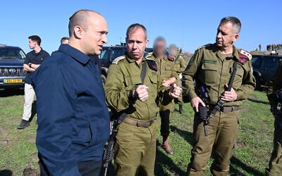 Then-Defense Minister Naftali Bennett (L) speaks with IDF Chief of Staff Aviv Kohavi (R) and Brig. Gen. Avi Gil, head of Northern Command's 36th Division, in the Golan Heights on December 18, 2019. (Ariel Hermoni/Defense Ministry)