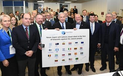Prime Minister Benjamin Netanyahu meets with visiting pro-Israel lawmakers from 25 countries in Jerusalem on December 9, 2019 (Amos Ben-Gershom/GPO)
