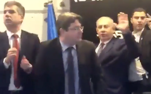 Prime Minister Benjamin Netanyahu waves as he is taken offstage during a Likud primary campaign rally in Ashkelon as rocket alerts sound, December 25, 2019. (Screenshot: Ynet) Prime Minister Benjamin Netanyahu waves as he is taken offstage during a Likud primary campaign rally in Ashkelon as rocket alerts sound, December 25, 2019. (Screenshot: Ynet)