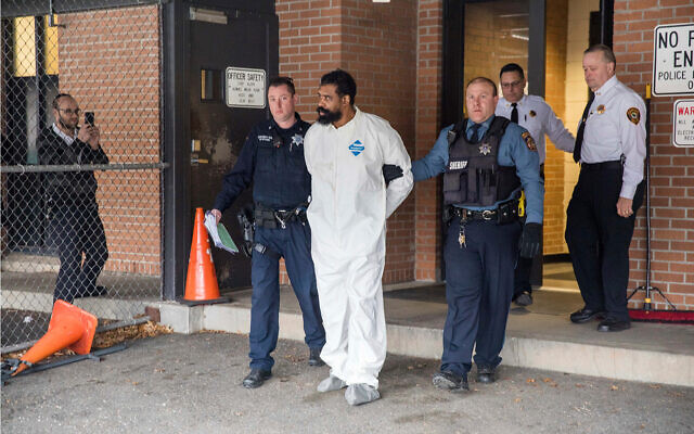 Ramapo police officers escort Grafton Thomas from Ramapo Town Hall to a police vehicle, December 29, 2019, in Ramapo, New York. (AP Photo/Julius Constantine Motal) Ramapo police officers escort Grafton Thomas from Ramapo Town Hall to a police vehicle, December 29, 2019, in Ramapo, New York. (AP Photo/Julius Constantine Motal)