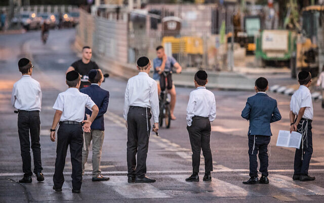 Illustrative: Ultra-Orthodox protesters block a road in Bnei Brak to oppose light rail construction work taking place on Shabbat, September 21, 2018. (Roy Alima/Flash90) Illustrative: Ultra-Orthodox protesters block a road in Bnei Brak to oppose light rail construction work taking place on Shabbat, September 21, 2018. (Roy Alima/Flash90)