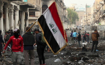 Anti-government protesters gather during clashes with security forces in Baghdad, Iraq, December 6, 2019. (AP Photo/Hadi Mizban)
