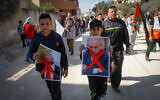 Palestinian demonstrators hold pictures of US President Donald Trump and and Prime Minister Benjamin Netanyahu during a protest in the village of Kfar Qaddum, near the West Bank city of Nablus, November 29, 2019. (Nasser Ishtayeh/Flash90)