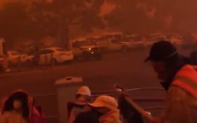 People preparing to evacuate as fires hem in the city of Mallacoota, Victoria, Australia. (screen capture: YouTube)