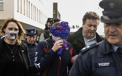 A British teenager (C) accused of falsely claiming she was raped by Israeli tourists covers her face as she leaves after the verdict at the Famagusta District Court in Paralimni in eastern Cyprus, on December 30, 2019. (Iakovos Hatzistavrou / AFP)