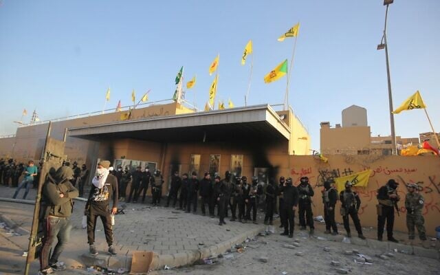 Iraqi security forces stand guard at the entrance of US embassy in the capital Baghdad after supporters and members of the Popular Mobilization Force militia breached the outer wall of the compound during a rally to vent anger over weekend air strikes that killed pro-Iran fighters in western Iraq, on December 31, 2019. (AHMAD AL-RUBAYE/AFP) Iraqi security forces stand guard at the entrance of US embassy in the capital Baghdad after supporters and members of the Popular Mobilization Force militia breached the outer wall of the compound during a rally to vent anger over weekend air strikes that killed pro-Iran fighters in western Iraq, on December 31, 2019. (AHMAD AL-RUBAYE/AFP)