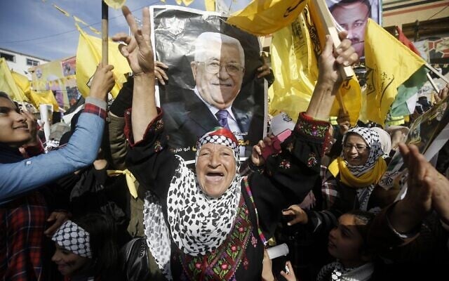 Supporters of the Palestinian Fatah movement, carry the portrait of Fatah chairman and Palestinian Authority President Mahmoud Abbas, during a rally marking the 55th foundation anniversary of the political party, in Gaza City on January 1, 2020. (Mohammed Abed/AFP) Supporters of the Palestinian Fatah movement, carry the portrait of Fatah chairman and Palestinian Authority President Mahmoud Abbas, during a rally marking the 55th foundation anniversary of the political party, in Gaza City on January 1, 2020. (Mohammed Abed/AFP)
