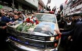 Mourners surround a car carrying the coffin of Iranian military commander Qassem Soleimani, killed alongside Iraqi paramilitary chief Abu Mahdi al-Muhandis in a US air strike, during a funeral procession in Kadhimiya, a Shiite pilgrimage district of Baghdad, on January 4, 2020 (SABAH ARAR / AFP)