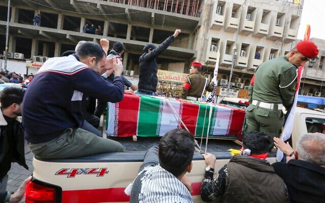 Mourners surround a car carrying the coffin of Iranian military commander Qassem Soleimani, killed alongside Iraqi paramilitary chief Abu Mahdi al-Muhandis in a US air strike, during a funeral procession in Kadhimiya, a Shiite pilgrimage district of Baghdad, on January 4, 2020 (SABAH ARAR / AFP) Mourners surround a car carrying the coffin of Iranian military commander Qassem Soleimani, killed alongside Iraqi paramilitary chief Abu Mahdi al-Muhandis in a US air strike, during a funeral procession in Kadhimiya, a Shiite pilgrimage district of Baghdad, on January 4, 2020 (SABAH ARAR / AFP)