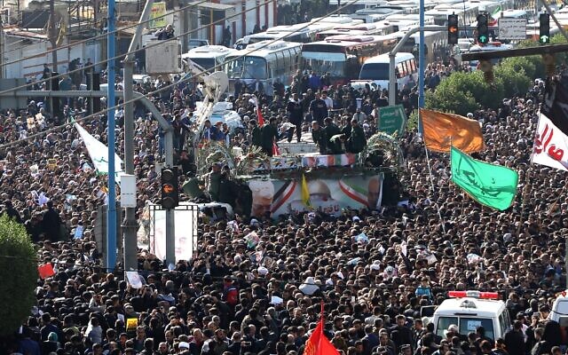 A large crowd surrounds the coffins of slain top commander Qasem Soleimani and Iraqi paramilitary chief Abu Mahdi al-Muhandis, as they are transported atop a vehicle after their arrival at Ahvaz International Airport in southwestern Iran on January 5, 2020. (FATEMEH RAHIMAVIAN / fars news / AFP) A large crowd surrounds the coffins of slain top commander Qasem Soleimani and Iraqi paramilitary chief Abu Mahdi al-Muhandis, as they are transported atop a vehicle after their arrival at Ahvaz International Airport in southwestern Iran on January 5, 2020. (FATEMEH RAHIMAVIAN / fars news / AFP)