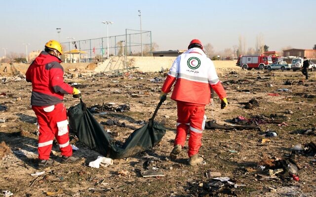 Rescue teams recover a body after a Ukrainian plane carrying 176 passengers crashed near Imam Khomeini airport in the Iranian capital Tehran on January 8, 2020, killing everyone on board. (AFP) Rescue teams recover a body after a Ukrainian plane carrying 176 passengers crashed near Imam Khomeini airport in the Iranian capital Tehran on January 8, 2020, killing everyone on board. (AFP)