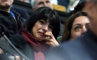 A woman weeps during a memorial service at the University of Toronto in Toronto, Ontario on January 12, 2020 for the victims of Ukrainian Airlines flight 752 which was shot down over Iran this past week.  (Photo by Geoff Robins / AFP)